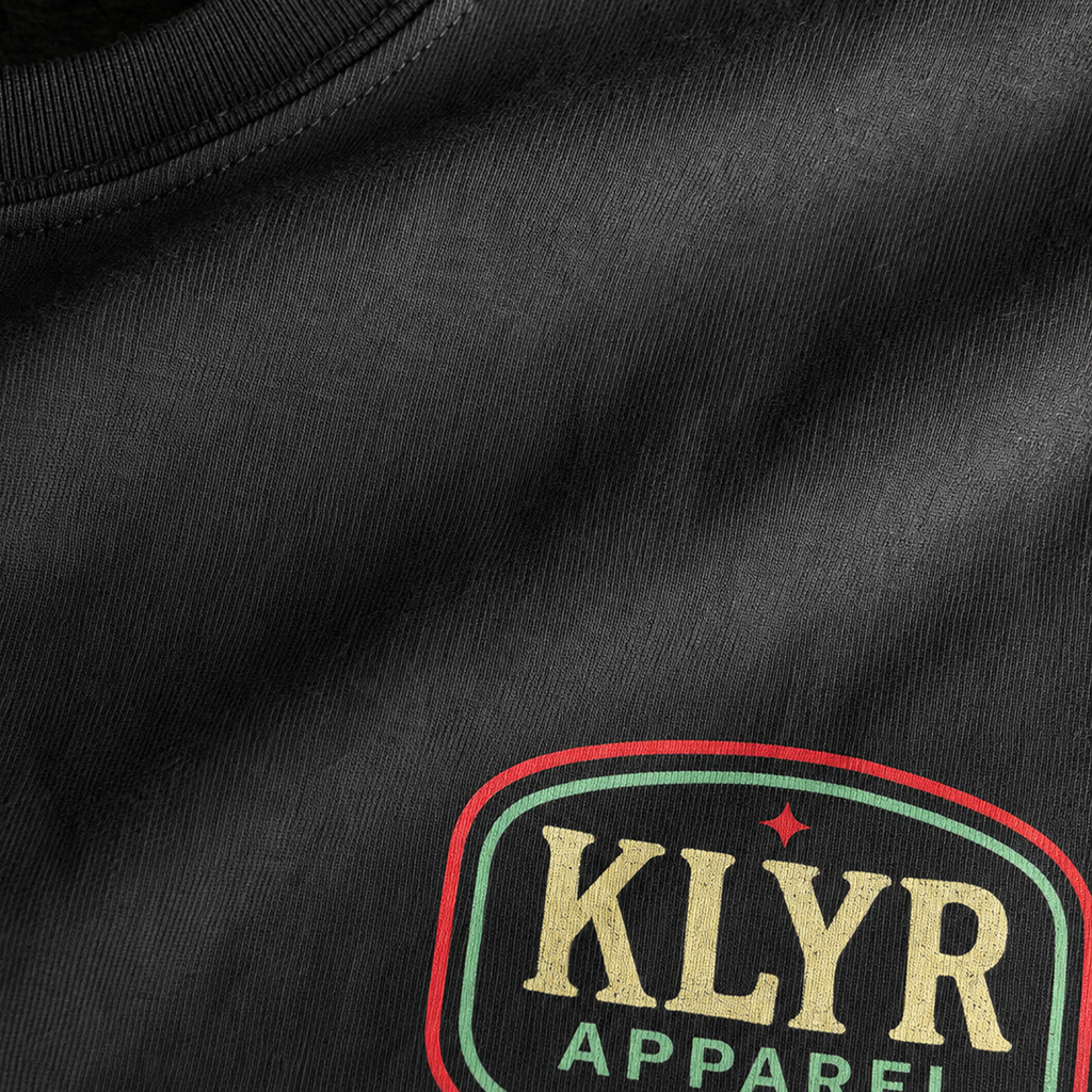 Close-up of the premium Next Level 6210 fabric and KLYR Apparel chest logo on the black After Hours Tee.
