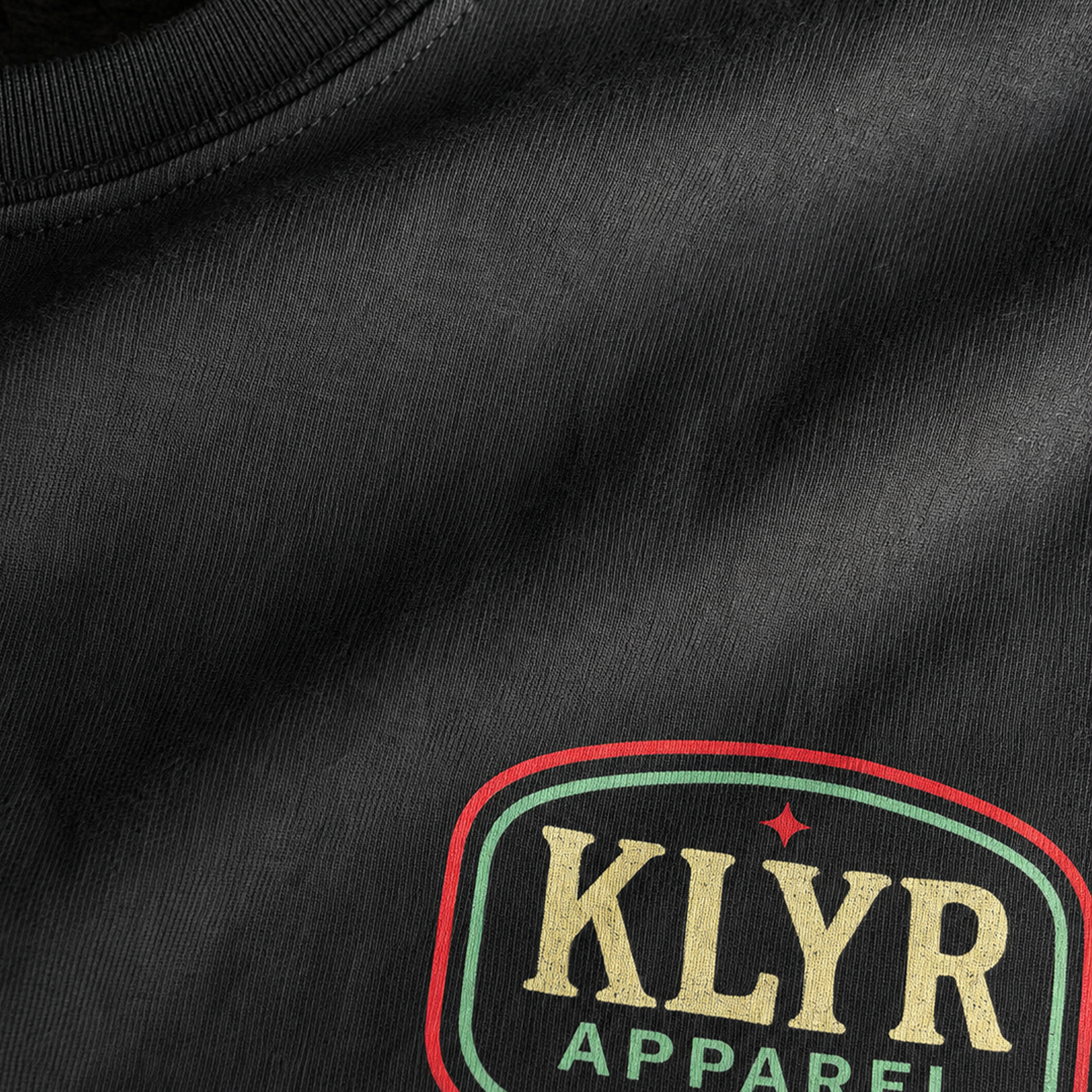Close-up of the premium Next Level 6210 fabric and KLYR Apparel chest logo on the black After Hours Tee.
