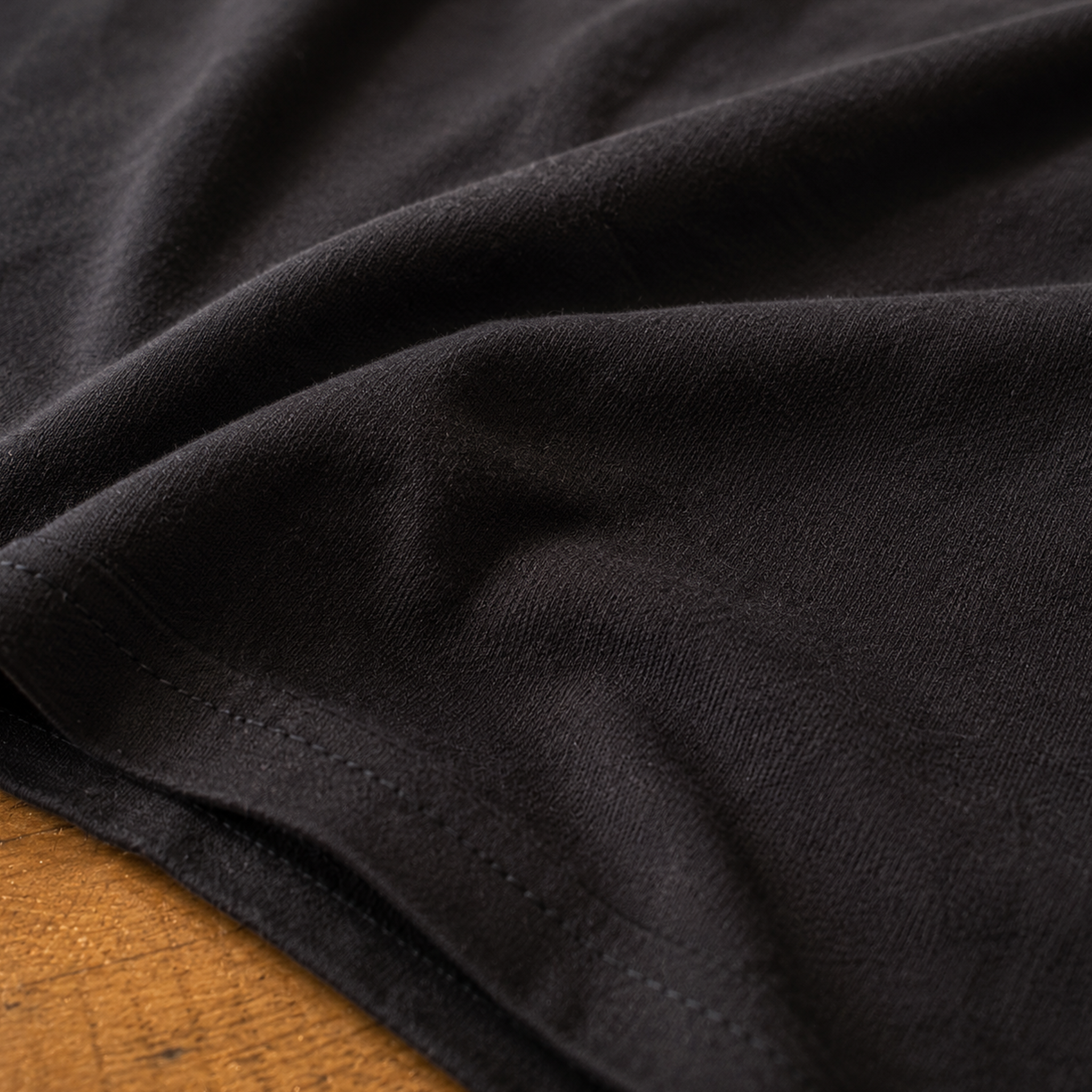 Close-up of the premium Next Level 6210 CVC fabric on the black KLYR Low Vis Tee highlighting its soft texture and quality stitching.