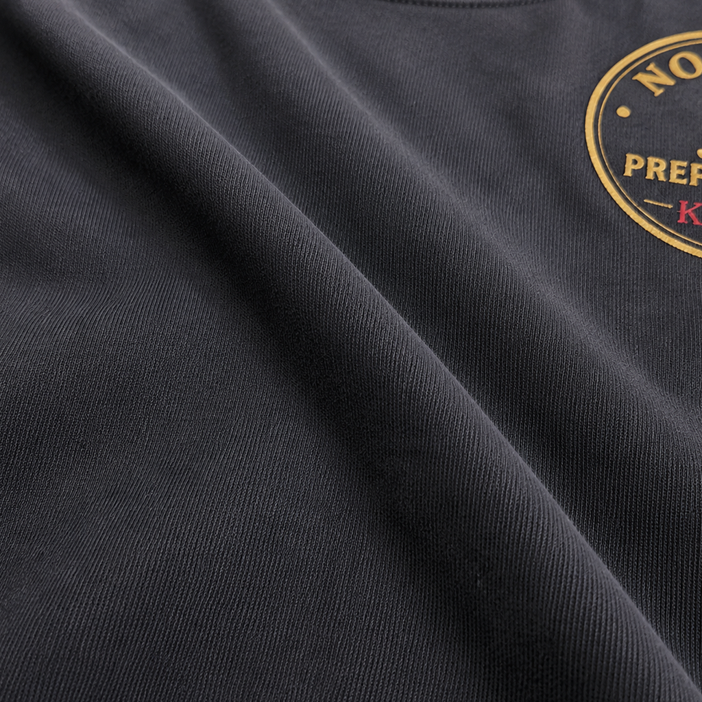 Close-up of the premium Next Level 6210 CVC fabric on the black KLYR Aces Tee highlighting its soft texture.