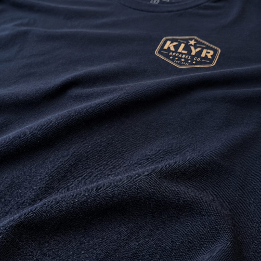 Close-up of the premium Next Level 6210 CVC fabric on the black KLYR Question Everything Tee highlighting its soft texture.
