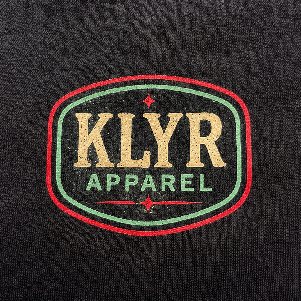 Detailed close-up of the vintage KLYR Apparel chest logo printed on the black After Hours Tee.