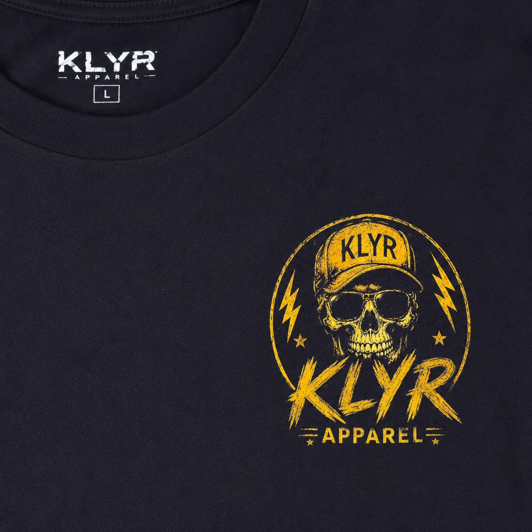 Close-up of the yellow KLYR Homies chest logo printed on the black tee.