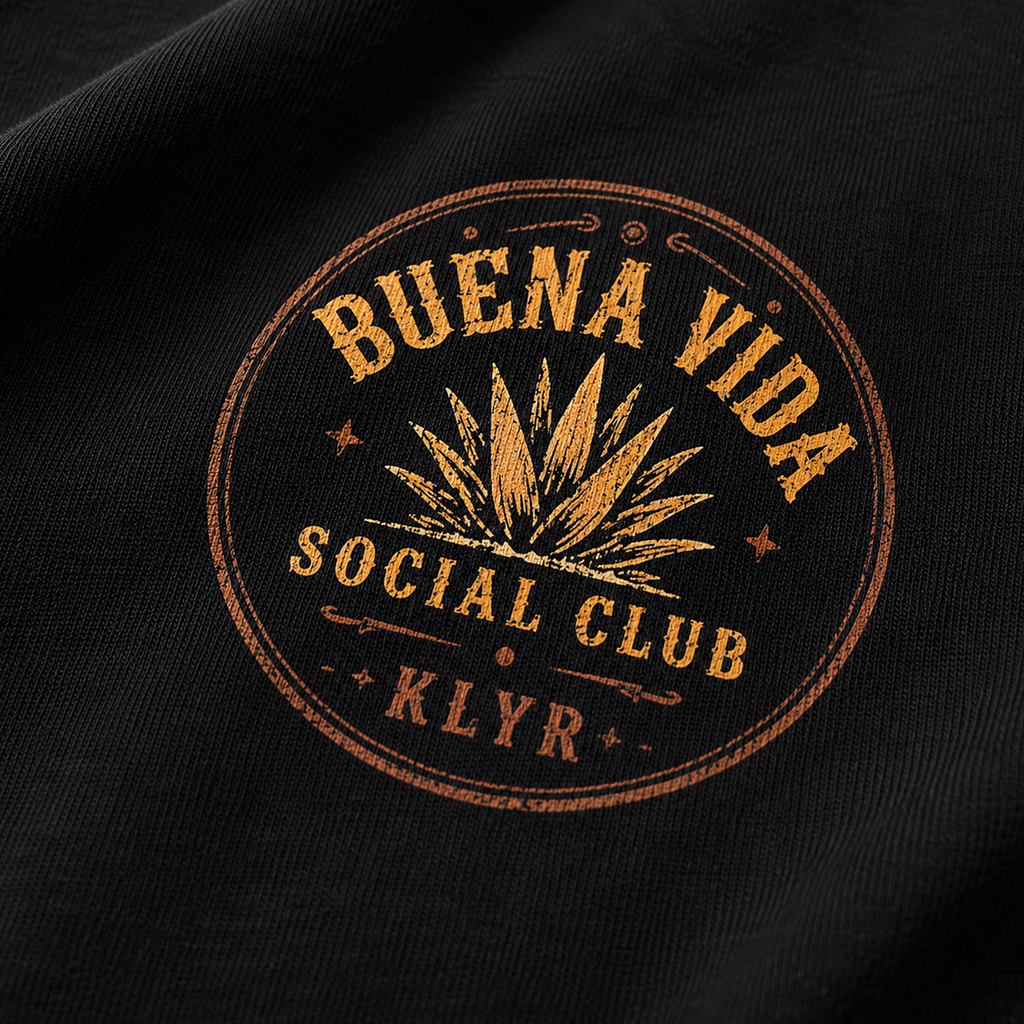 Close-up of the orange Buena Vida Social Club chest logo on the black tee.