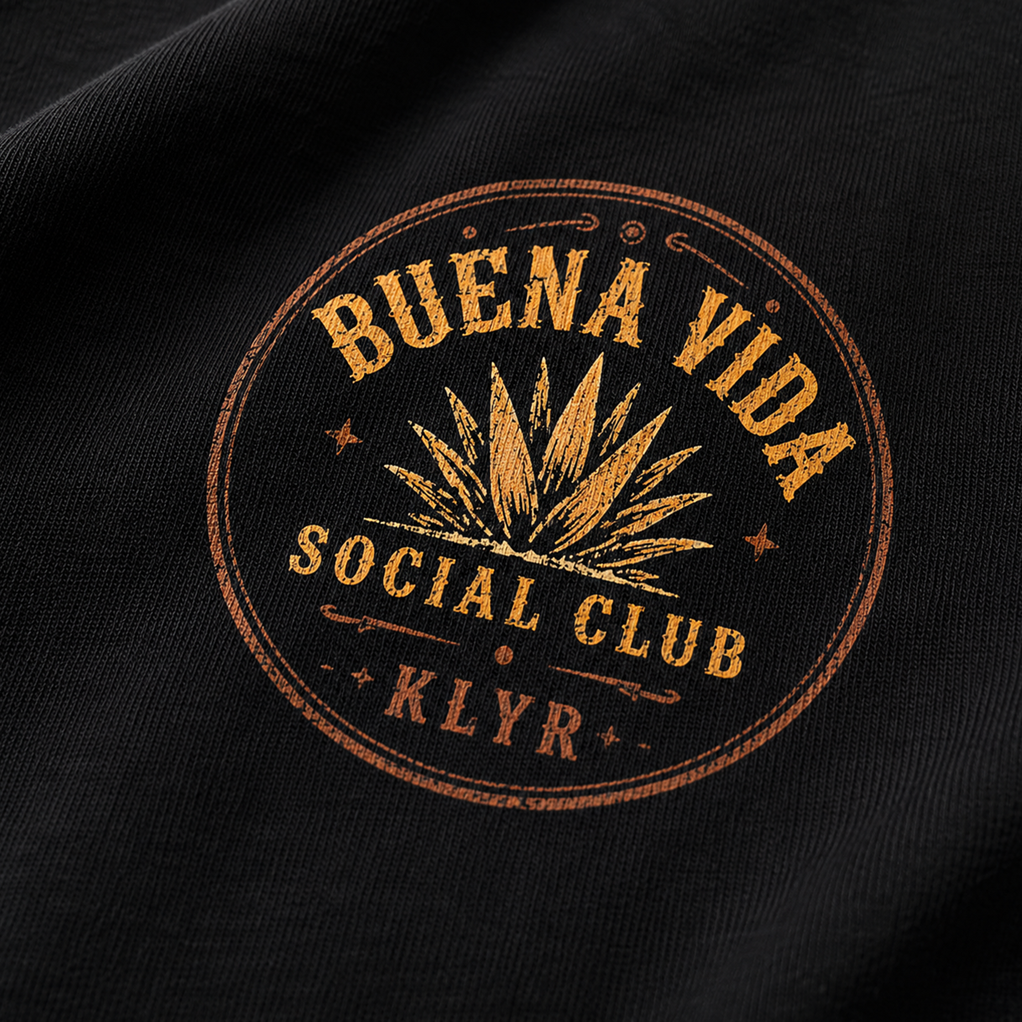 Close-up of the orange Buena Vida Social Club chest logo on the black tee.