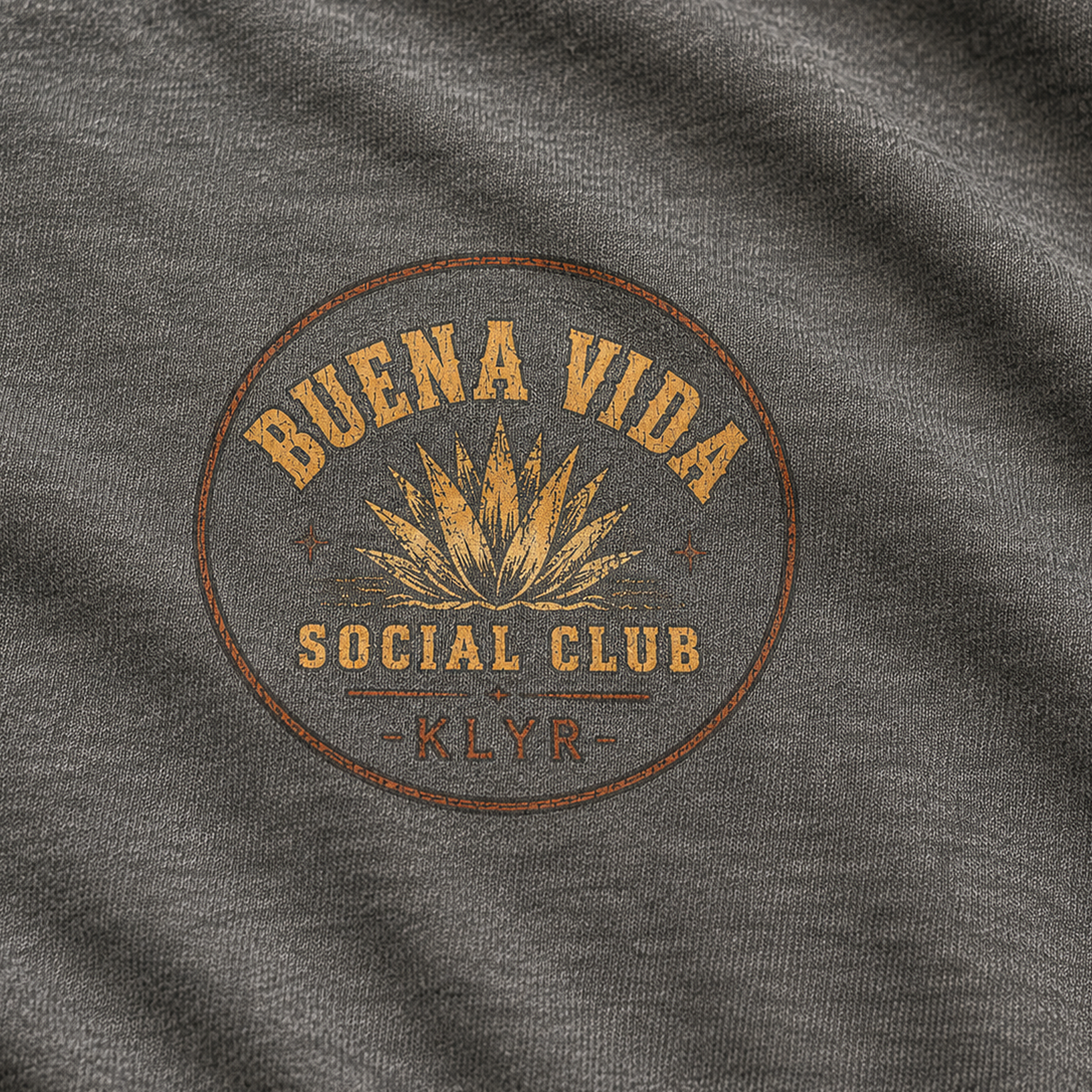 Close-up of the orange Buena Vida Social Club chest logo on the Heather Heavy Metal tee.