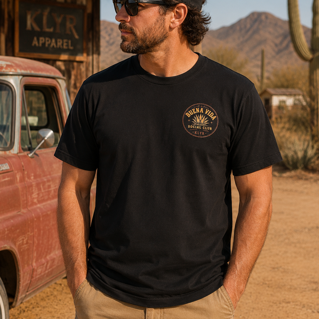 Person wearing the black Buena Vida Social Club Tee with the orange chest logo visible.
