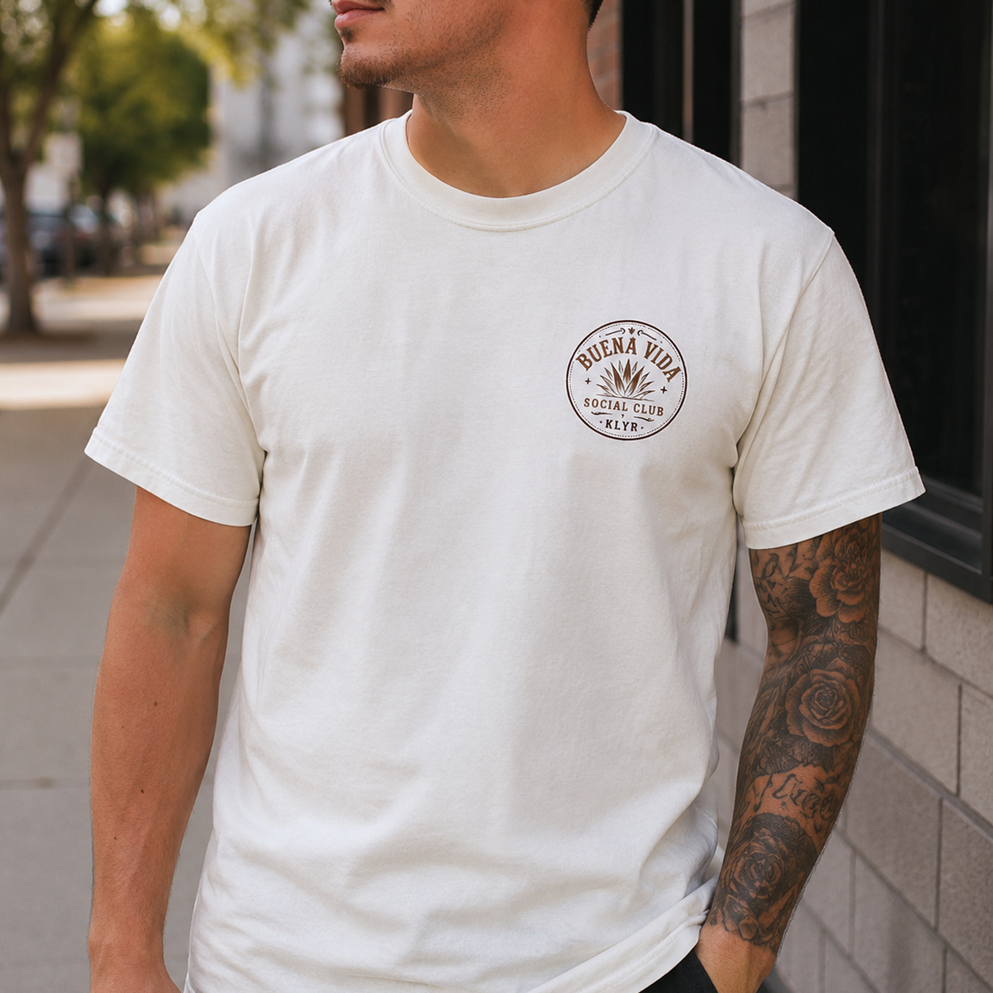 Person wearing the white Buena Vida Social Club Tee with the circular chest logo visible.