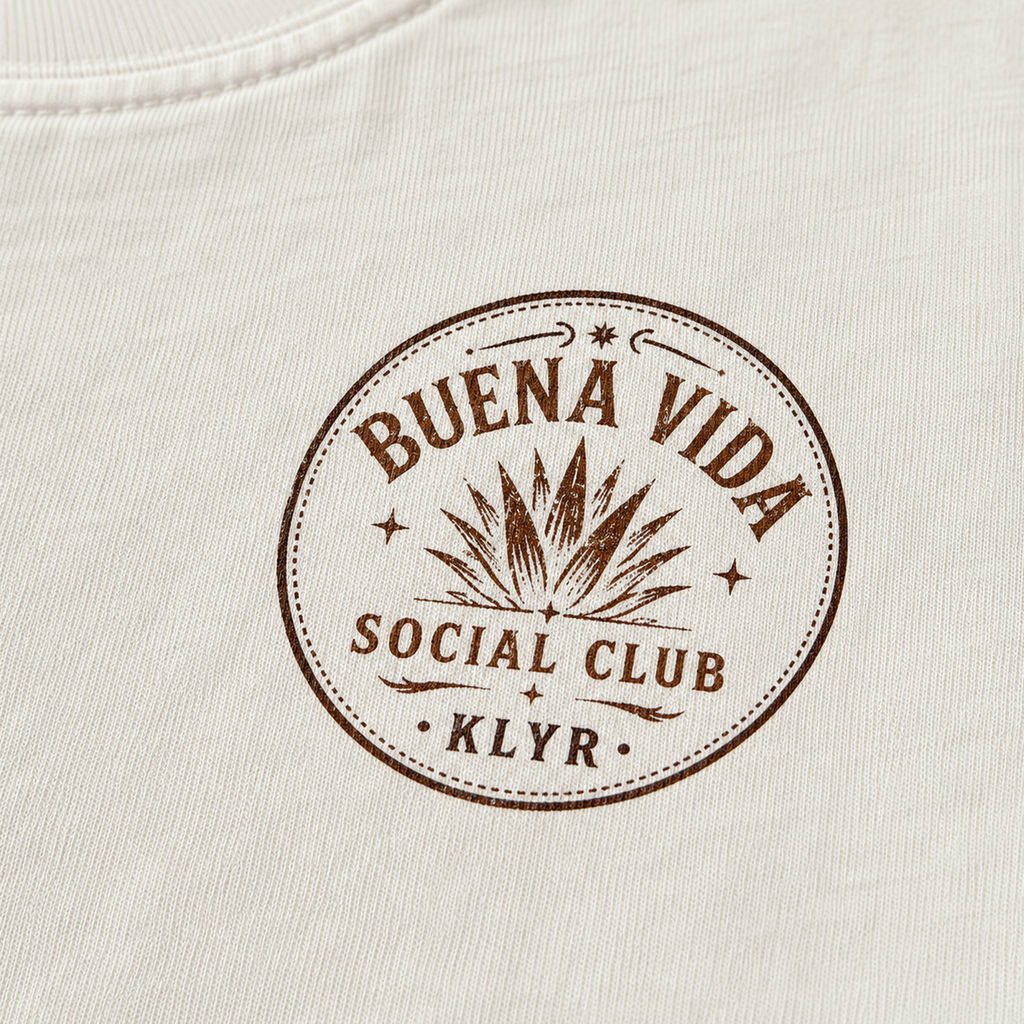 Close-up of the circular Buena Vida Social Club chest logo on the white tee.
