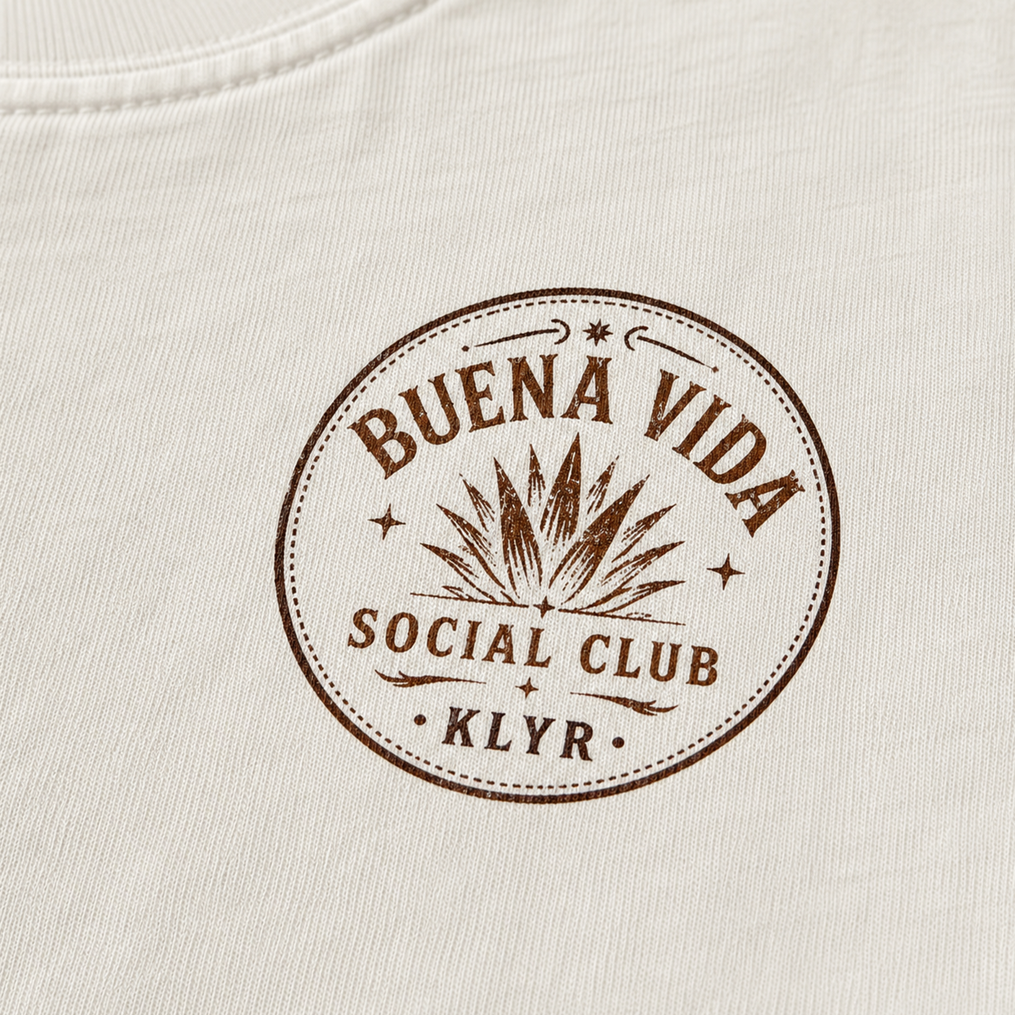 Close-up of the circular Buena Vida Social Club chest logo on the white tee.