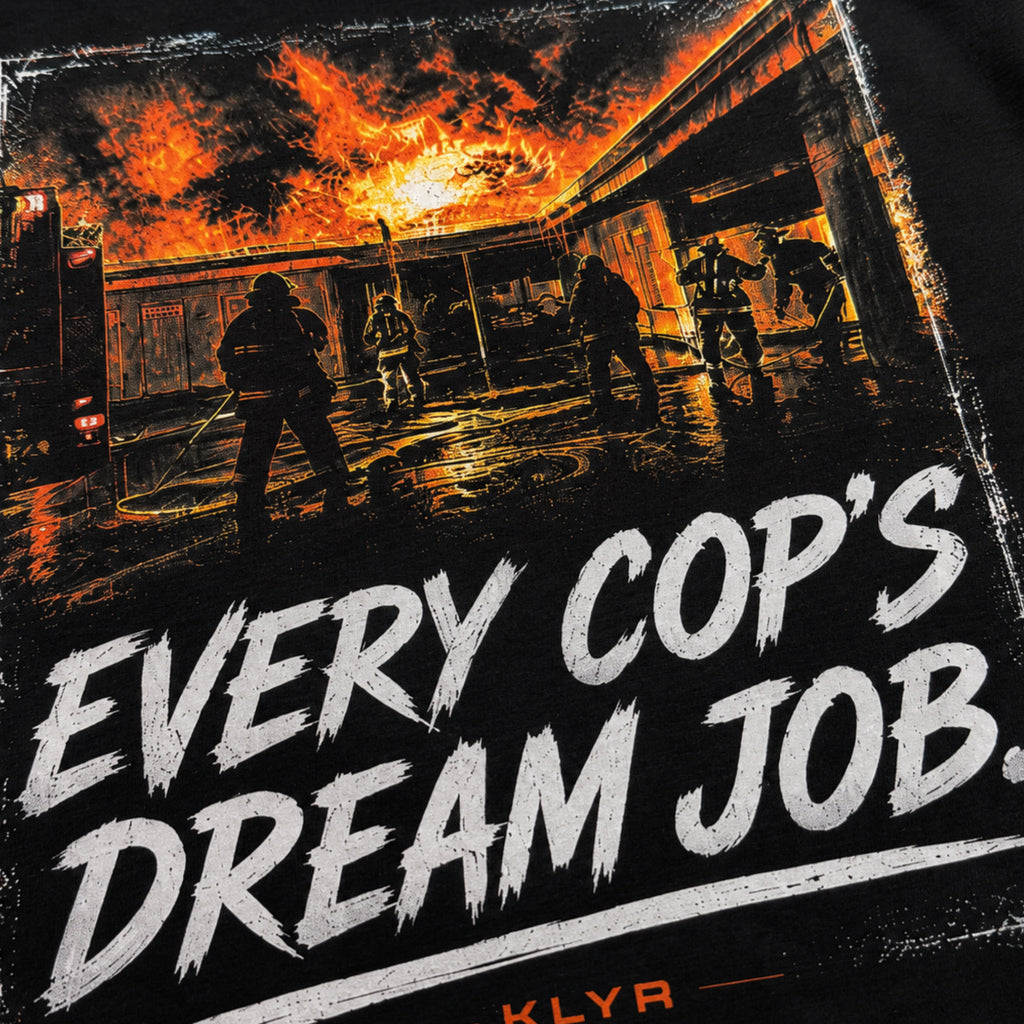 Close-up of the fiery Every Cop’s Dream Job back artwork on the black KLYR tee.