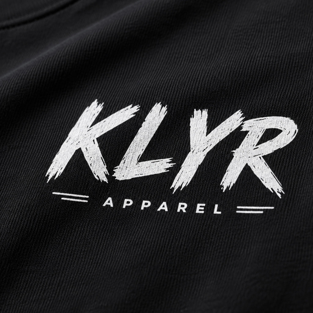 Close-up of the distressed white KLYR Apparel chest logo.