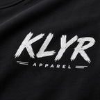 Close-up of the distressed white KLYR chest logo on the Every Cop's Dream Job Tee. 