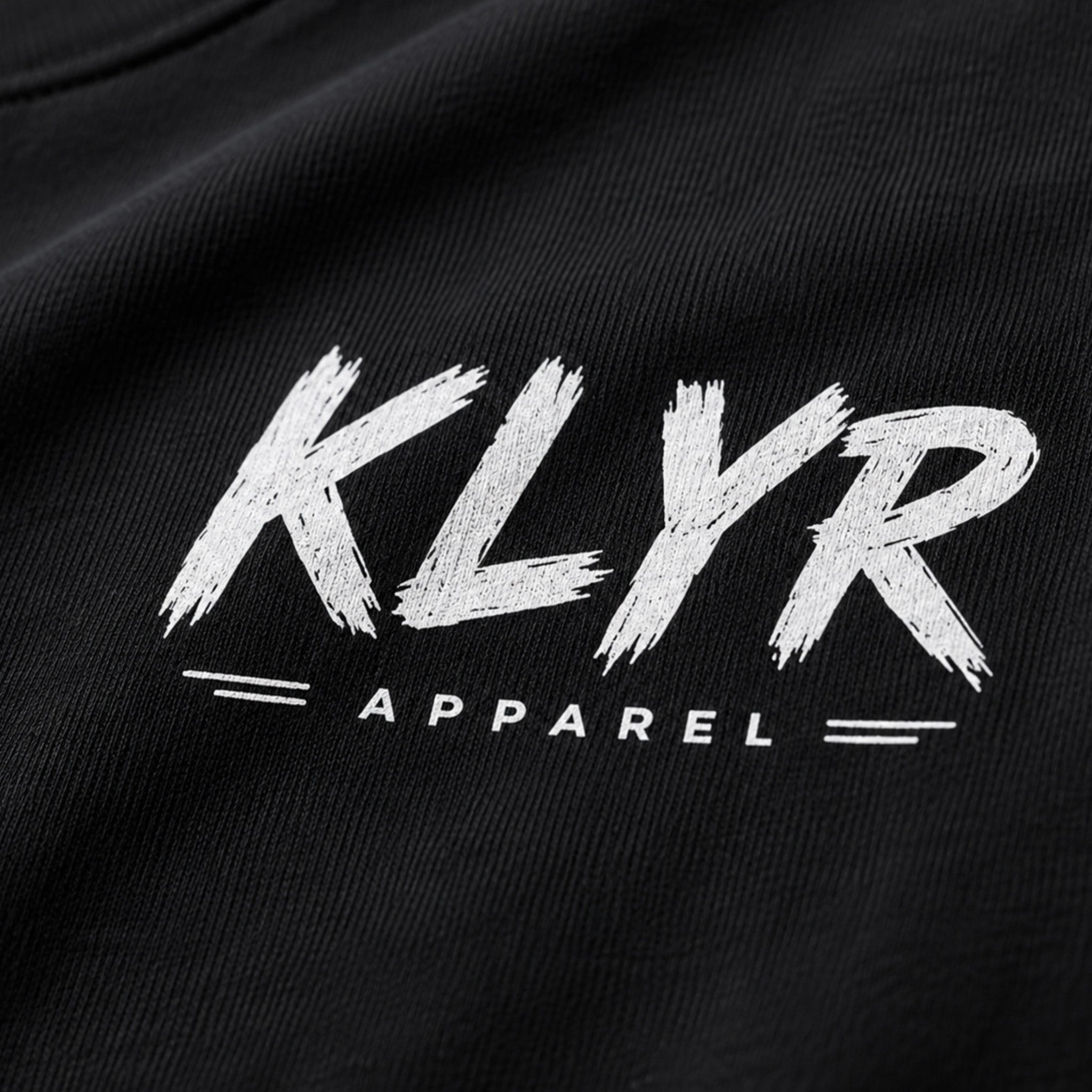 Close-up of the distressed white KLYR Apparel chest logo.