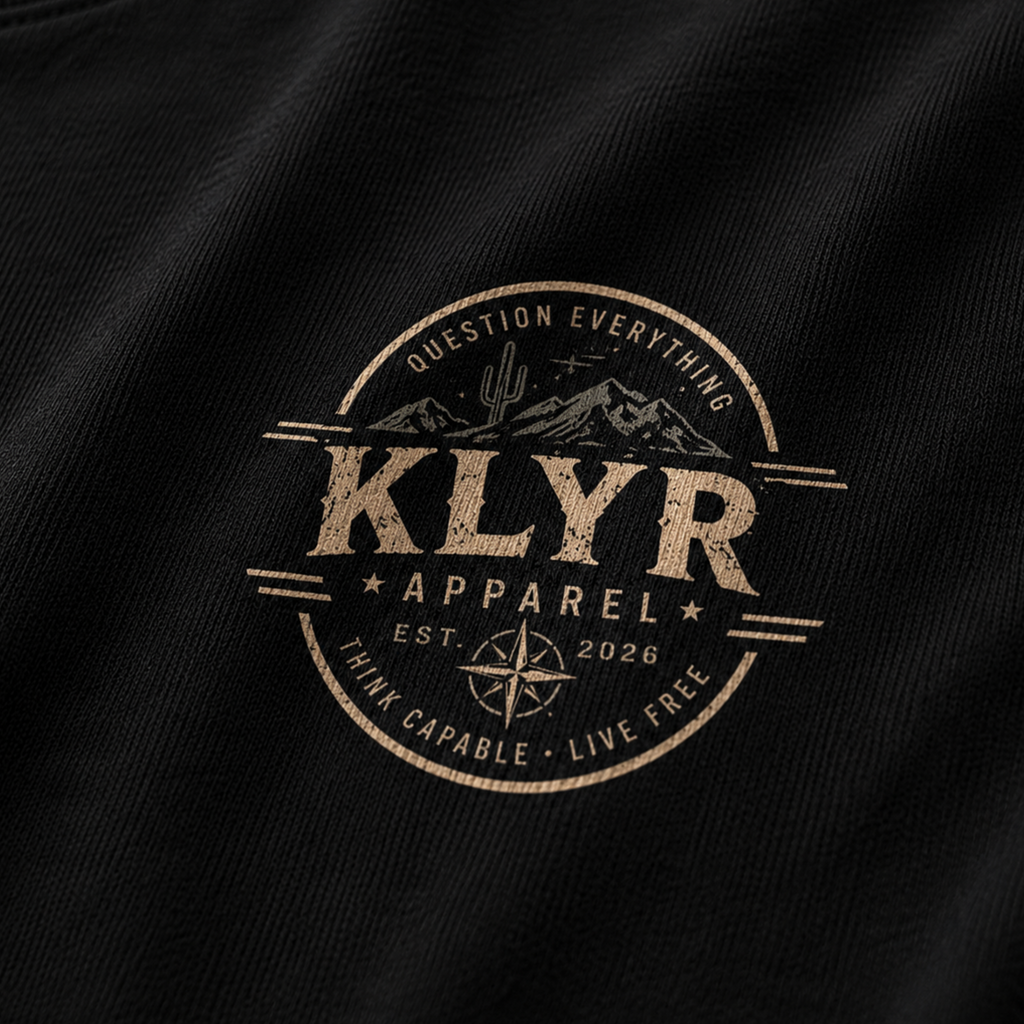 Close-up of the desert-inspired KLYR Apparel chest badge on the Freedom Is Not Negotiable Tee.