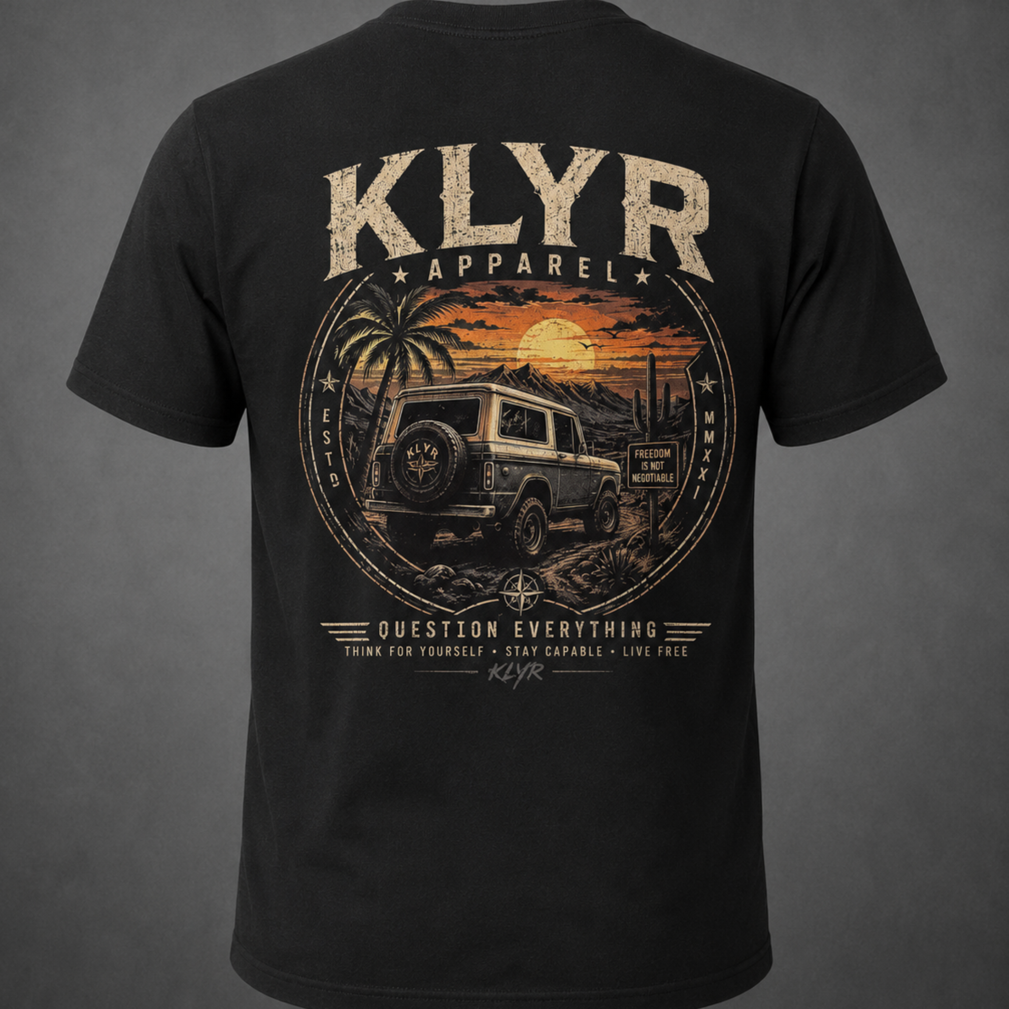 Back view of the black KLYR Freedom Is Not Negotiable Tee featuring an off-road vehicle in a desert sunset.