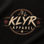 Close-up of the KLYR chest mark on the black Fueled by Coffee Tee. 