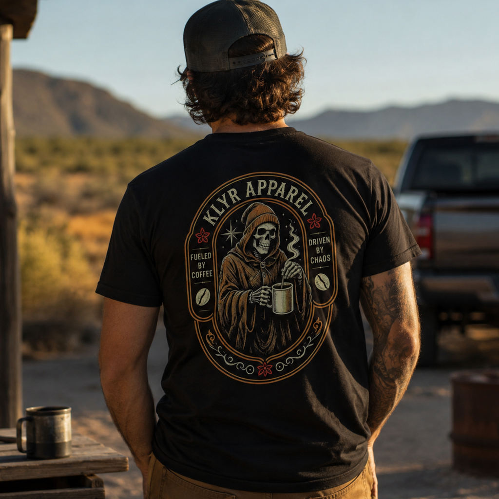 Person wearing the black Fueled by Coffee Tee while holding a coffee mug with the full skeleton back graphic visible.
