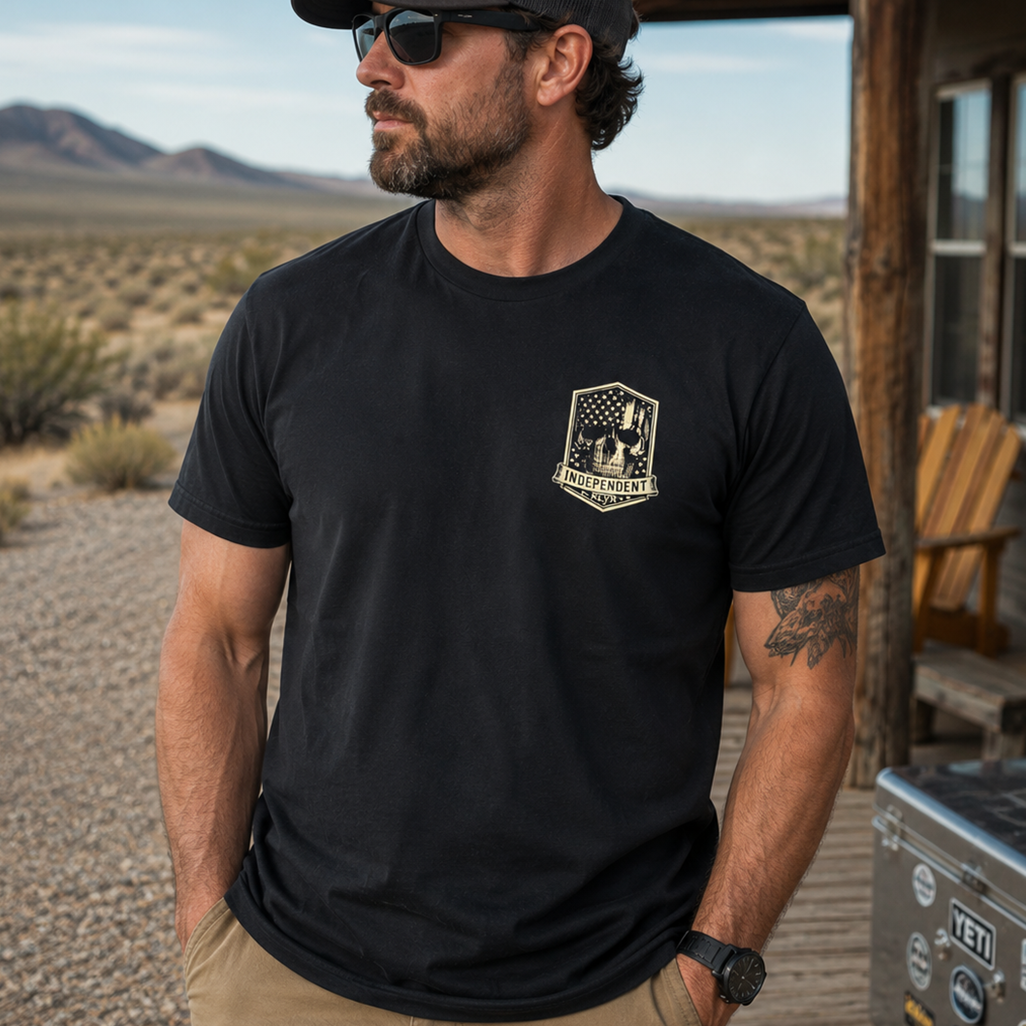 Person wearing the black Independent Tee with the cream KLYR chest badge visible.