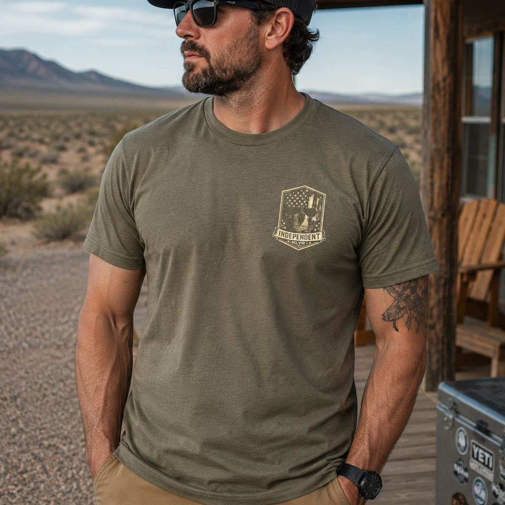 Person wearing the military green Independent Tee with the Independent chest badge visible.