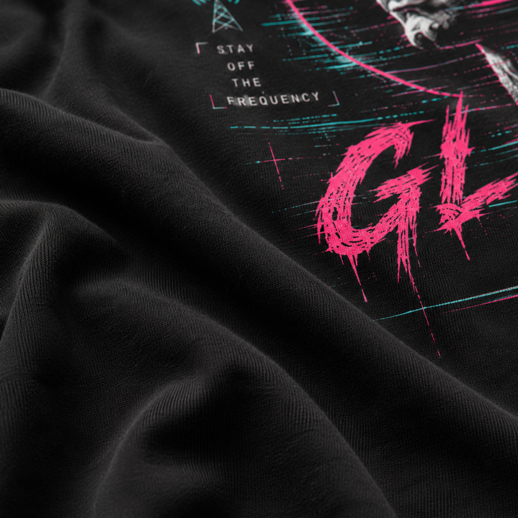 Close-up of the soft black Next Level 6210 fabric and neon printed detail on the Reality Glitch Tee.