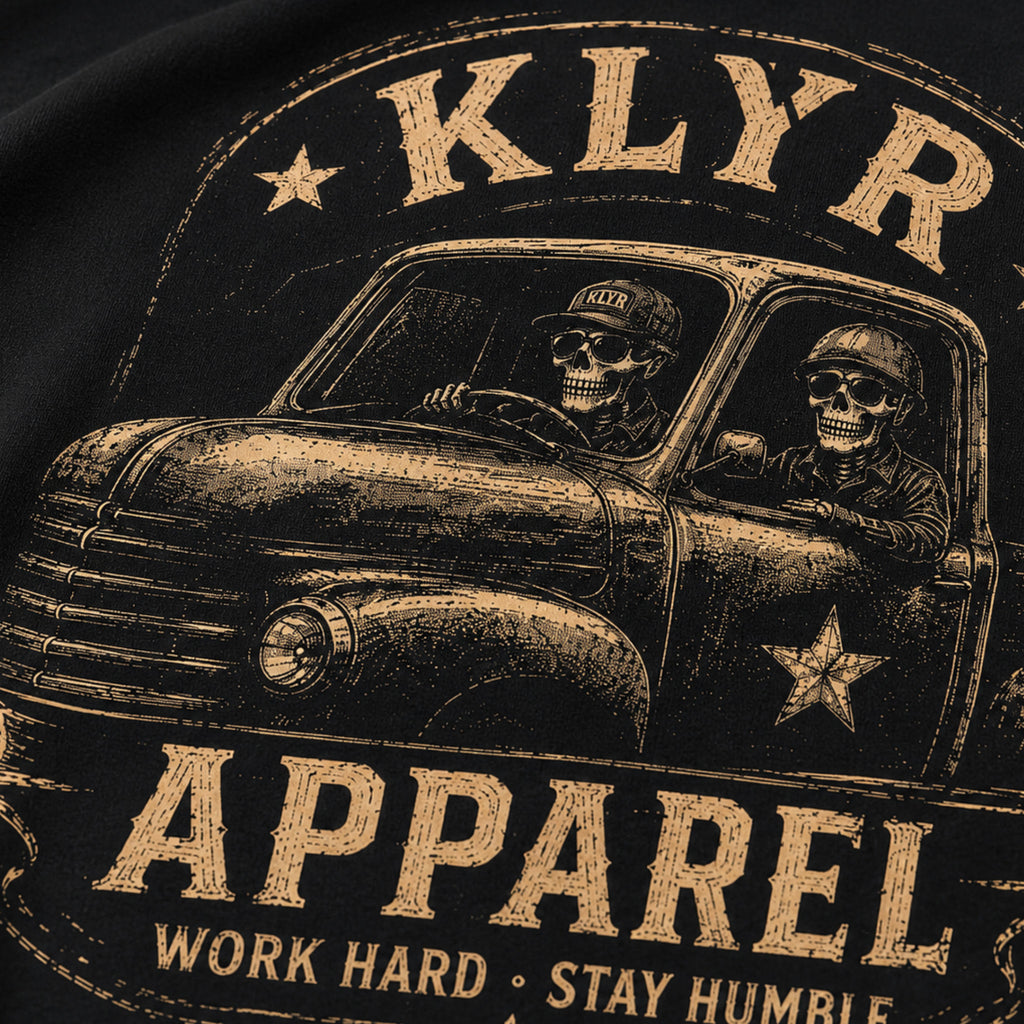 Close-up of the distressed vintage pickup and skeleton artwork on the Work Hard Stay Humble Tee.