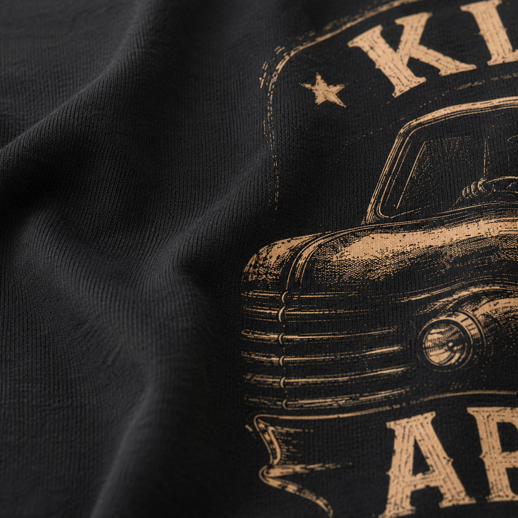 Close-up of the soft black Next Level 6210 fabric and distressed cream print on the Work Hard Stay Humble Tee.