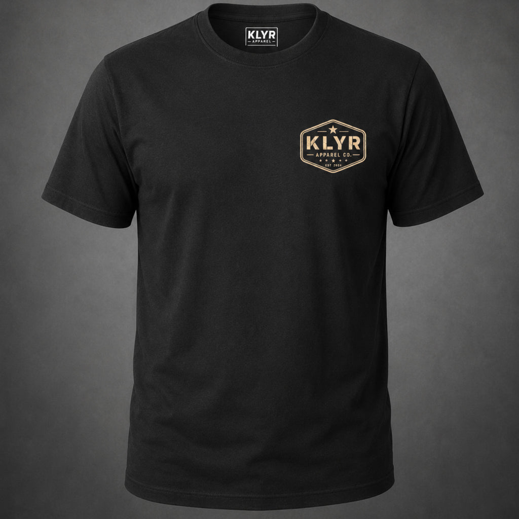 Front view of the black Work Hard Stay Humble Tee featuring a distressed cream KLYR Apparel chest badge.